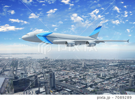 White passenger plane flying above a city White passenger plane flying above a city 7089289