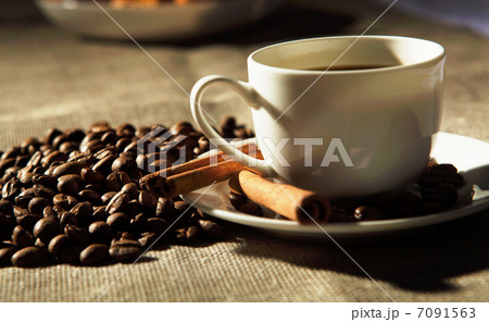 cup of coffee with tubes of cinnamon cup of coffee with tubes of cinnamon 7091563