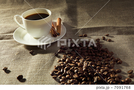 cup of coffee with tubes of cinnamon cup of coffee with tubes of cinnamon 7091768