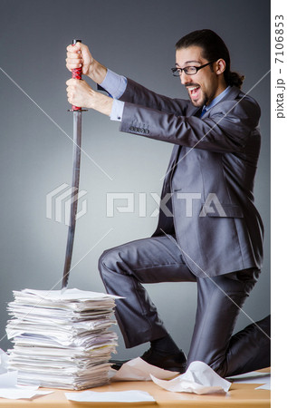 Businessman cutting the pile of paper Businessman cutting the pile of paper 7106853