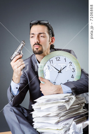 Man with clock and pile of papers 7106868