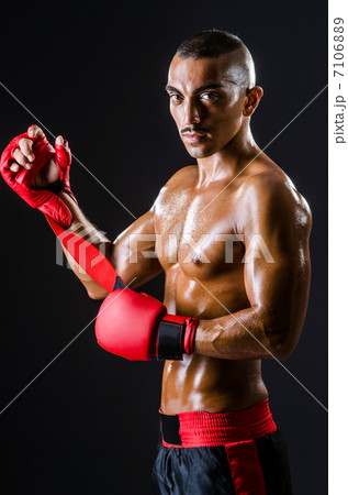 Boxer with red gloves in dark room Boxer with red gloves in dark room 7106889