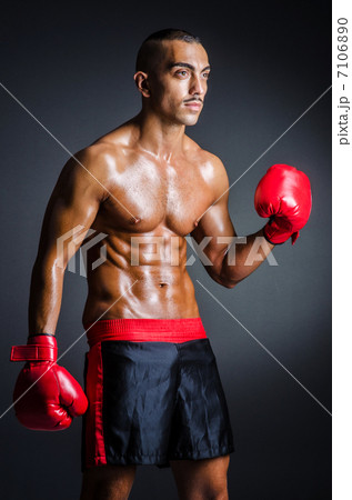 Boxer with red gloves in dark room Boxer with red gloves in dark room 7106890