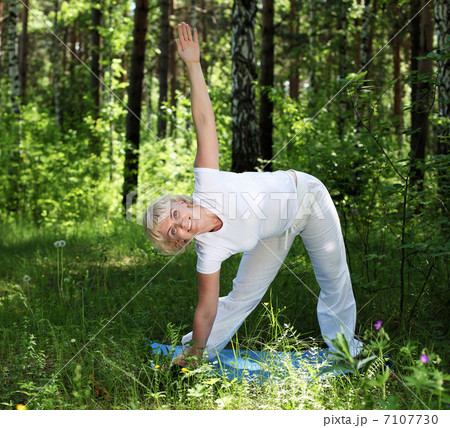 An elderly woman practices yoga An elderly woman practices yoga 7107730