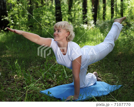 An elderly woman practices yoga 7107770