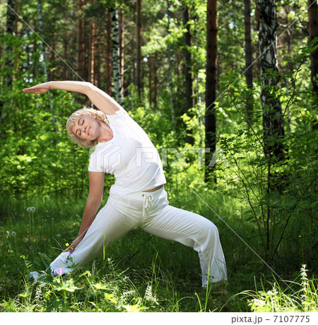 An elderly woman practices yoga 7107775