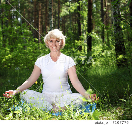 An elderly woman practices yoga An elderly woman practices yoga 7107776