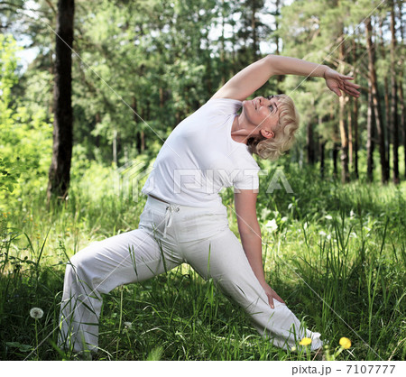 An elderly woman practices yoga An elderly woman practices yoga 7107777