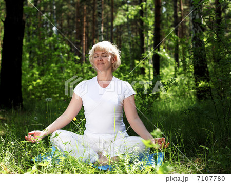 An elderly woman practices yoga 7107780