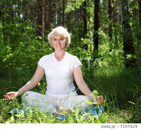 An elderly woman practices yoga An elderly woman practices yoga 7107829