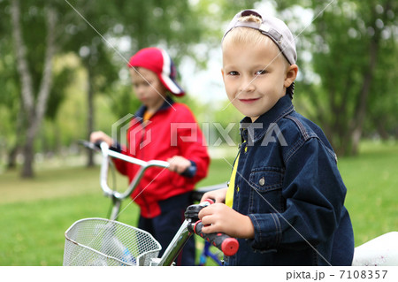 Boy on a bicycle in the green park 7108357