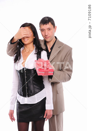young man gives his girlfriend a gift 7109186