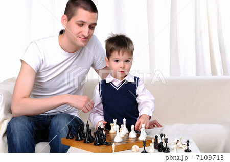 Dad and son playing chess Dad and son playing chess 7109713