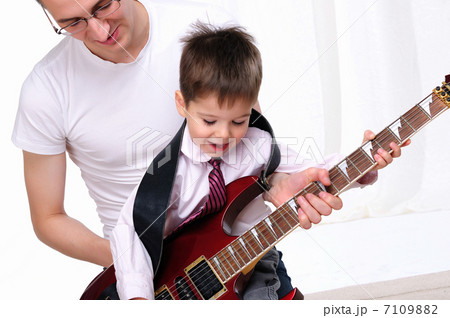 young father teaches his young son young father teaches his young son 7109882