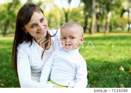 Young mother with her son in summer park Young mother with her son in summer park 7110286