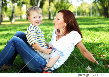 Young mother with her son in summer park Young mother with her son in summer park 7110366