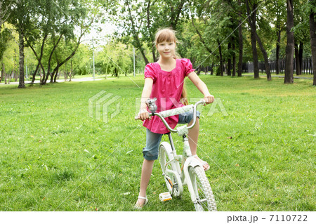 Girl with a bike in the park Girl with a bike in the park 7110722