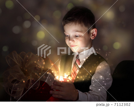 Child opening a magic gift box Child opening a magic gift box 7112302