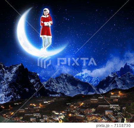 photo of santa claus sitting on the moon 7118730