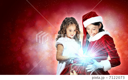 Little girl with christmas gifts and santa 7122073
