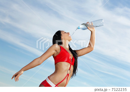 Young female sport girl with a bottle of water 7122235