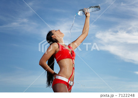 Young female sport girl with a bottle of water 7122248