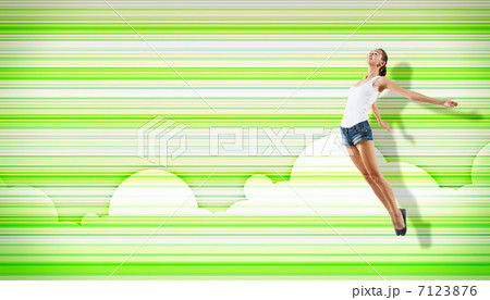 young woman dancing and jumping... 7123876