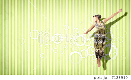 young woman dancing and jumping... 7123910