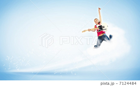 young woman playing on electro guitar and jumping 7124484
