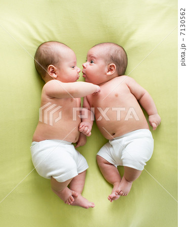 funny twins brothers babies lying on green 7130562