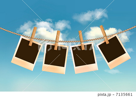 Retro photos hanging on a rope in front of a blue sky with cloud 7135661