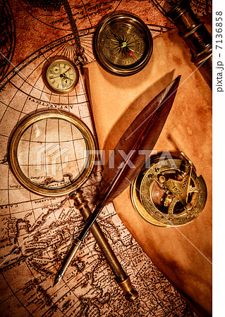 Vintage magnifying glass lies on an ancient world map 7136858