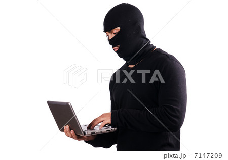 Hacker with computer wearing balaclava 7147209