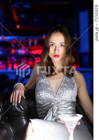 Young woman in night club with a drink Young woman in night club with a drink 7150926