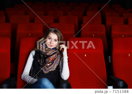 Young girl in cinema watching movie Young girl in cinema watching movie 7151388