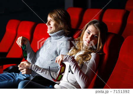 Young couple in cinema watching movie Young couple in cinema watching movie 7151392