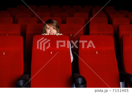 Young man in cinema watching movie Young man in cinema watching movie 7151405