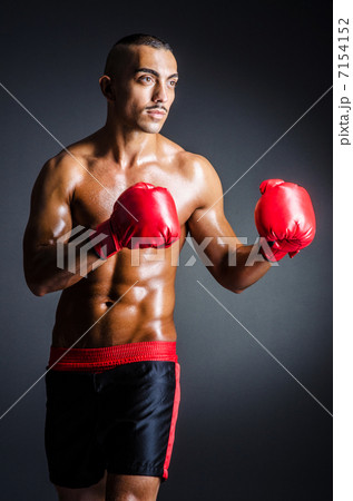 Boxer with red gloves in dark room Boxer with red gloves in dark room 7154152