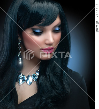Jewelry. Beautiful Brunette Girl with Holiday Makeup 7154403
