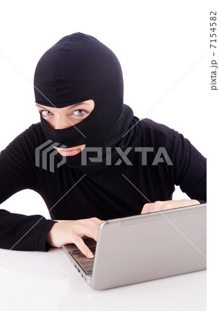Hacker with computer wearing balaclava Hacker with computer wearing balaclava 7154582