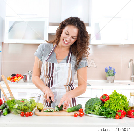 Young Woman Cooking. Healthy Food - Vegetable Salad 7155091