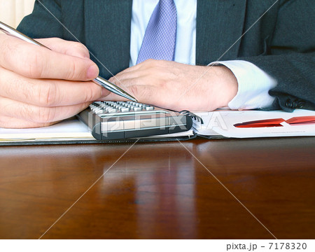 Businessman with calculator Businessman with calculator 7178320