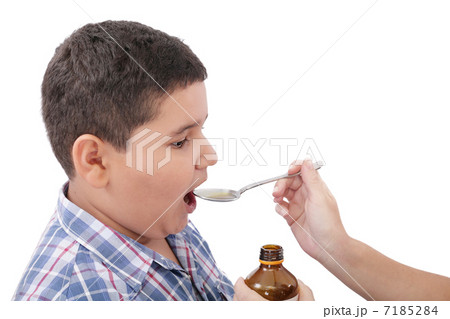 Child taking cough medicine because of the flu 7185284