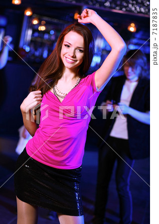 Young woman having fun at nightclub disco 7187835