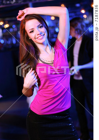 Young woman having fun at nightclub disco 7187836