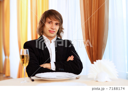 Young handsome man sitting in restaurant Young handsome man sitting in restaurant 7188174