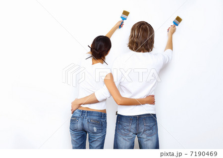 Young couple with paint brushes together Young couple with paint brushes together 7190469