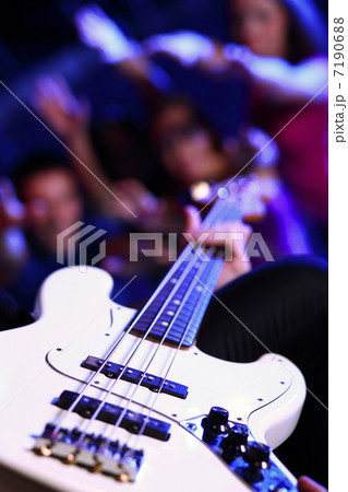 Young guitar player performing in night club 7190688
