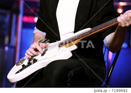 Young guitar player performing in night club 7190692