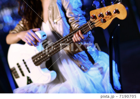 Young guitar player performing in night club 7190705